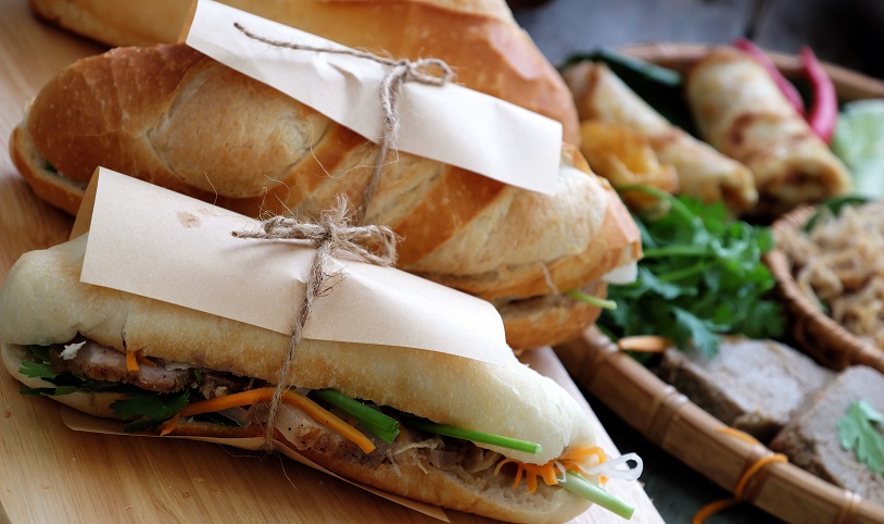 Famous Vietnamese food is Banh Mi Thit - bread stuffed with pork, ham, pate, egg and fresh herbs as scallions, coriander, carrot, cucumber, chilli....