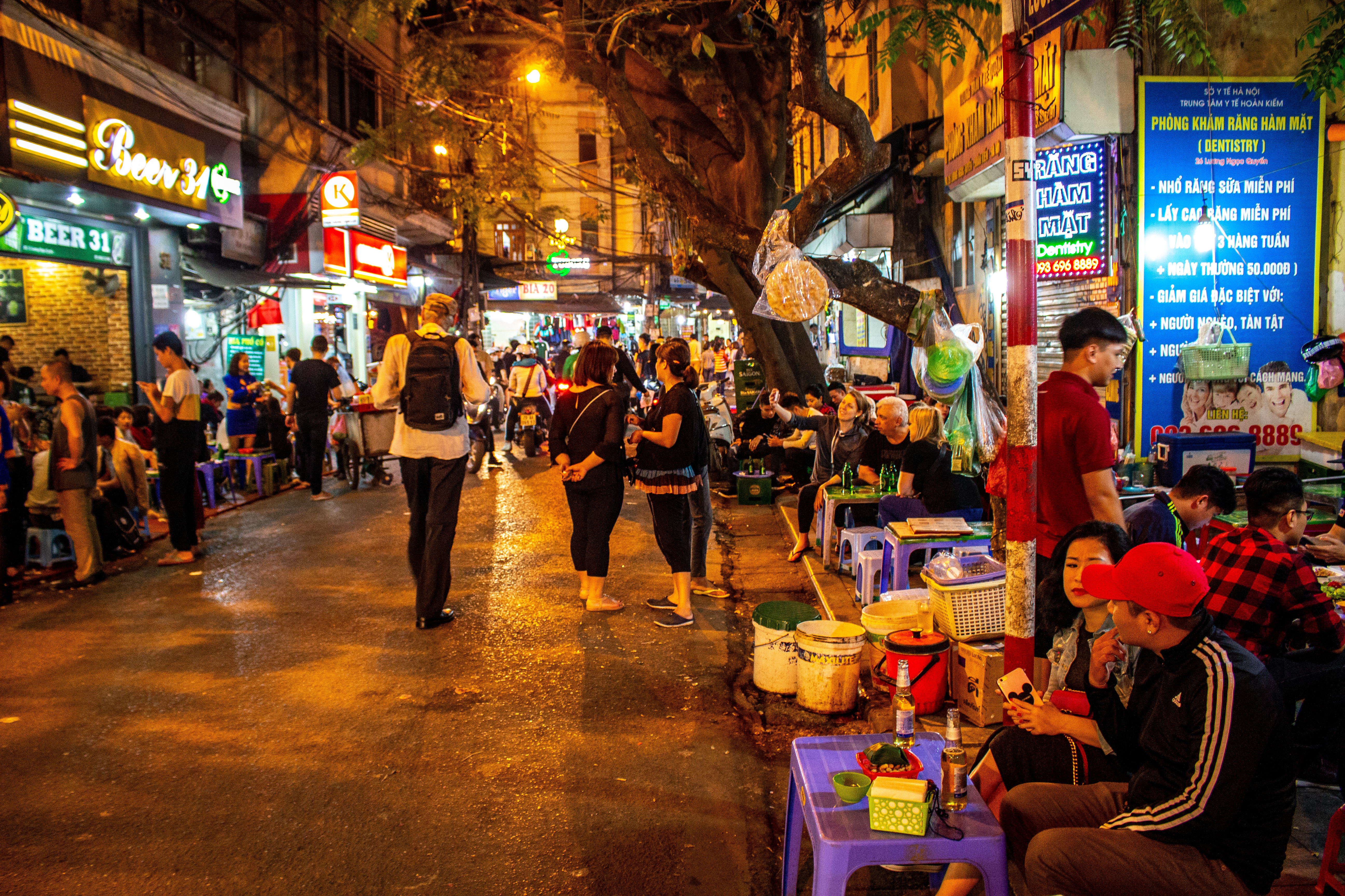 People enjoying the evening in the street with full of bars in Hanoi