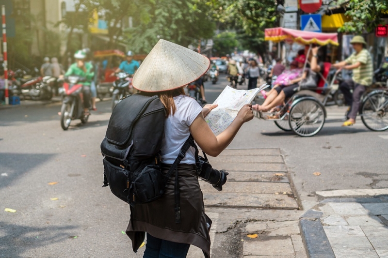 A Traveler holding and looking the map for travel in Hanoi